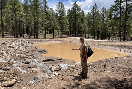 NAU graduate student Max Miller assisting Rebecca Beers (AZGS) with data collection on flood mitigation structure below Museum Fire burn scar.